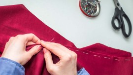 Seamstress sews clothes by hand